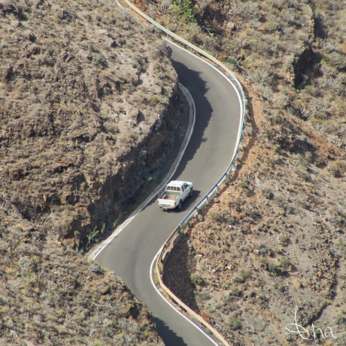 Pick-up truck driving in a small road on the dry island of Lanzarote